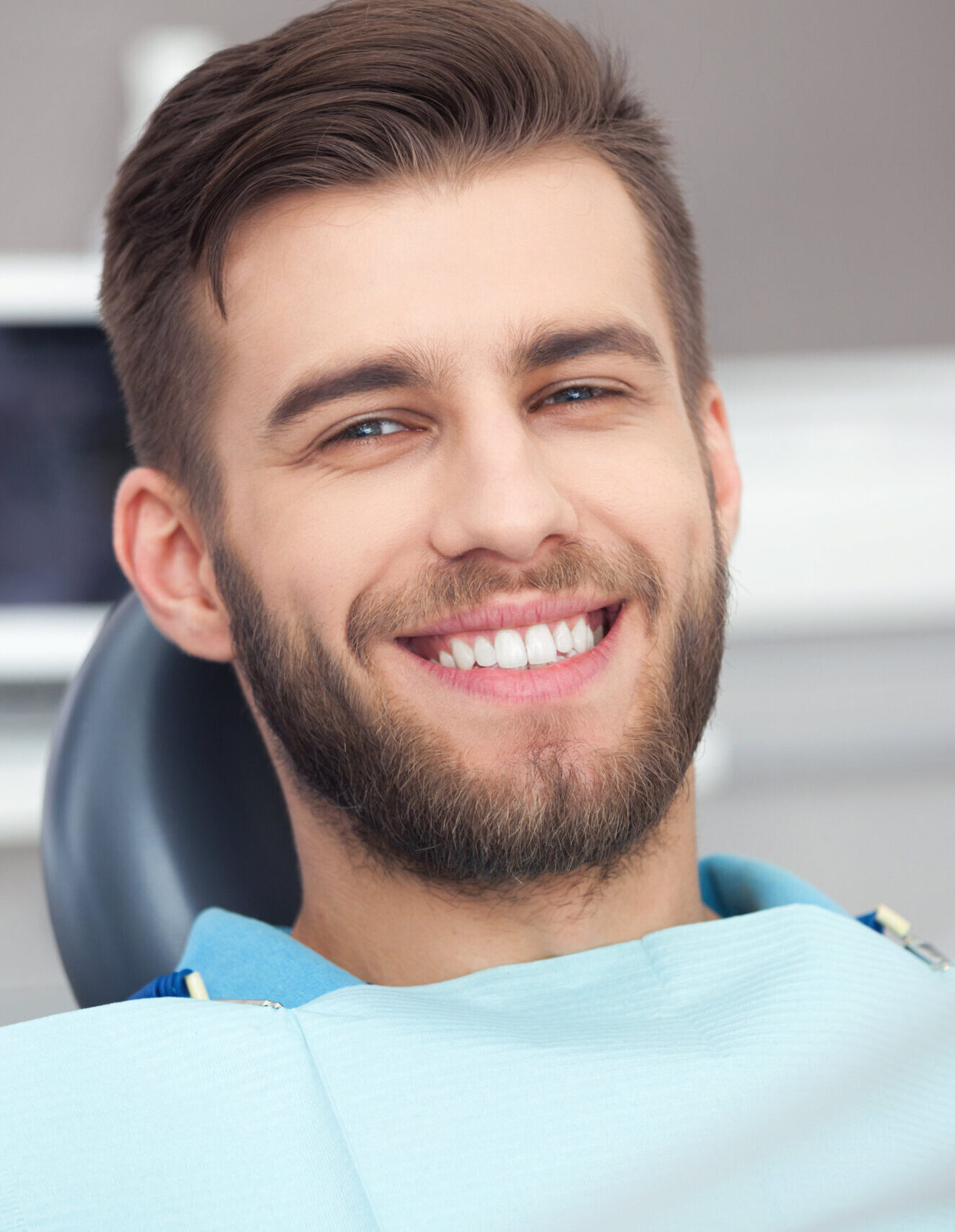 My smile is perfect! Portrait of happy patient in dental chair.