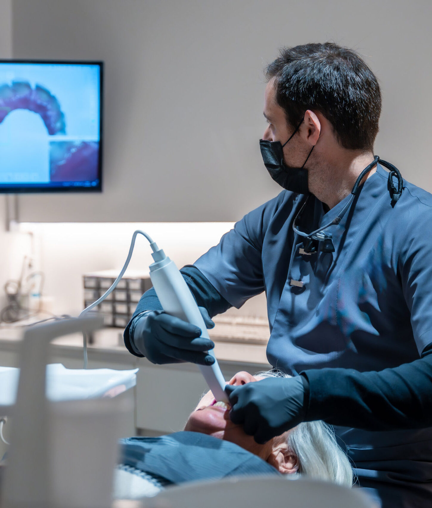 Dentist using an intraoral scanner for 3d scanning of teeth, creating precise digital models for diagnosis and treatment planning