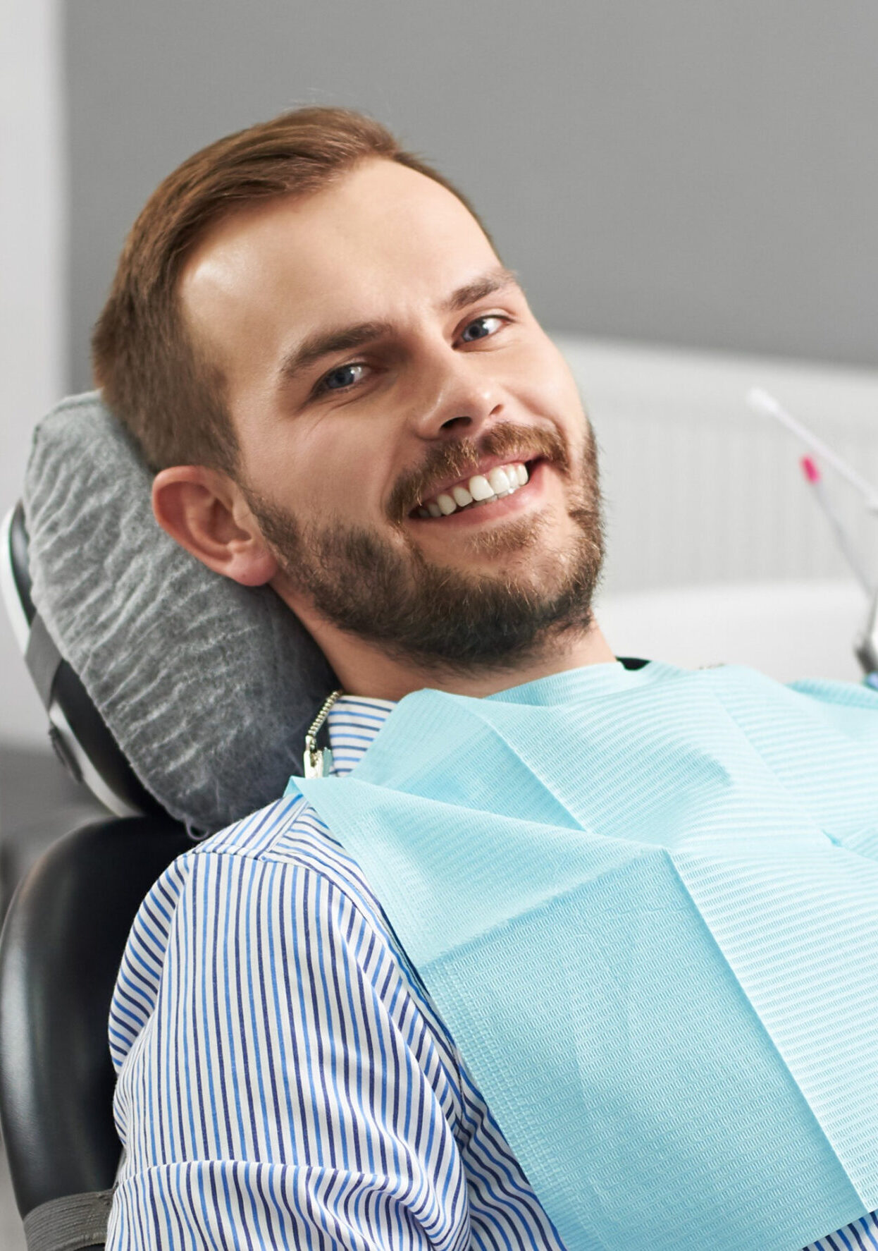 Portrait of happy patient in dental chair. Modern dentistry with the use of new technologies