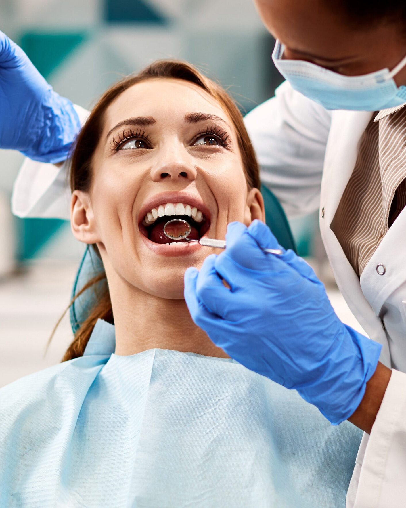 Happy woman having dental examination during appointment at dentist's office.